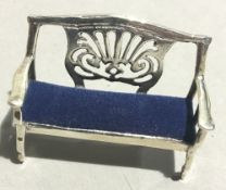 A miniature silver sofa