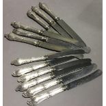 A set of six 800 silver butter knives and six matching table knives