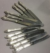 A set of six 800 silver butter knives and six matching table knives