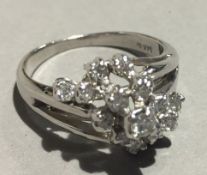 A 14 ct white gold diamond cluster ring (4.