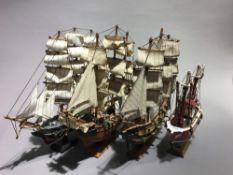 Four model sailing ships