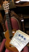 An acoustic guitar with labels for Jacques Camurat, Paris dated 1972 and Pamplona,