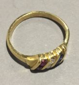 An 18 ct gold ruby, diamond and sapphire ring (3.