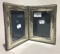 A hallmarked silver double photo frame