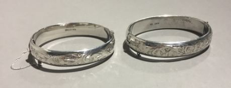 Two silver bangles form bracelets