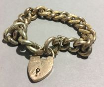 A 9 ct gold bracelet with 9 ct gold heart shaped padlock (23 grammes all in)