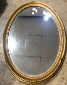 An oval gilt framed mirror