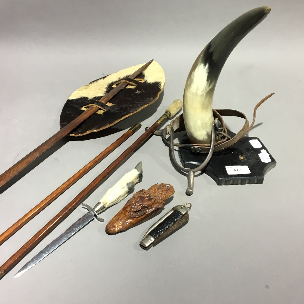 A 'Ring The Horn' cow horn, a taxidermy Cayman keyring, a gun rod and an African shield, etc.