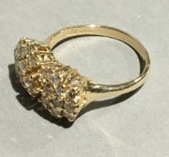 A 14 ct gold diamond cluster ring with central champagne coloured diamond