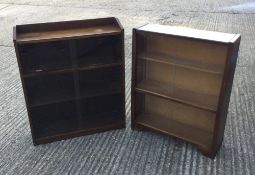 An oak glazed bookcase and another