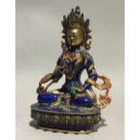 An enamel decorated model of Buddha