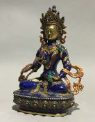 An enamel decorated model of Buddha