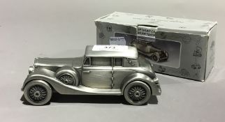 A pewter veteran car money box