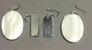 Two pairs of silver and shell earrings