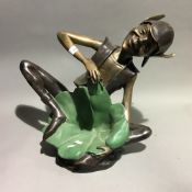 A bronze model of a pixie