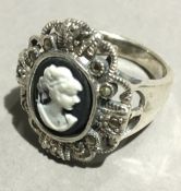 A silver and marcasite cameo ring
