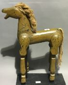 A vintage small wooden toy horse