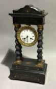 A 19th century ebonised portico clock