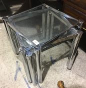 A nest of three chrome tables