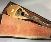 A late 19th/early 20th century cased Neapolitan mandolin bearing label Dco Brambilla Napoli