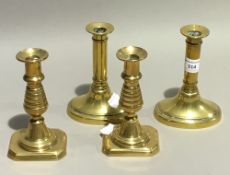 Two pairs of Georgian brass candlesticks