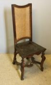 An early 19th century solid seated cane back chair