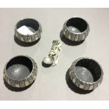 Four silver salts and spoons