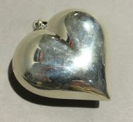 A silver heart shaped pendant