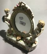 A porcelain cherub mirror