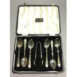 A set of cased silver teaspoons and tongs