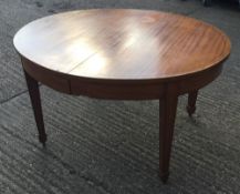 A late 19th/early 20th century French oval satinwood extendable dining table