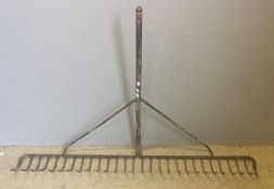 A large metal hay rake