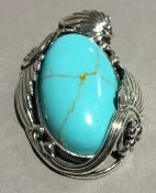 A silver and turquoise pendant