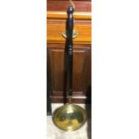 A brass bed warming pan with griddle work decoration