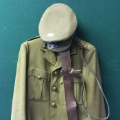 A WWII British Army officer's tunic, a Sam Browne belt and cap,