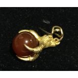 A 9 ct gold eagle claw and agate pendant