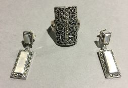 A silver and marcasite ring and earrings