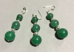 A silver and jade earring and pendant set