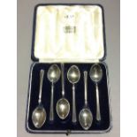A cased set of enamel decorated silver teaspoons (approx 2 troy ozs)