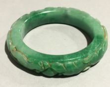 A carved jade bangle