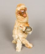 A 19th century French plush covered clockwork monkey Worked with a papier mache face and striking a