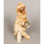 A 19th century French plush covered clockwork monkey Worked with a papier mache face and striking a