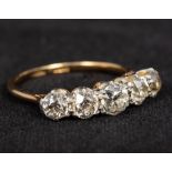 An 18 ct gold and platinum five stone diamond ring The central stone approximately 0.4 carat.