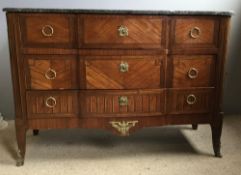 A 19th century Continental gilt metal mounted kingwood marble topped commode chest The shaped black