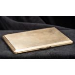 A 9 ct gold cigarette case Of hinged chamfered rectangular form, with engine turned engraving,