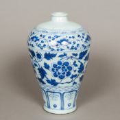A Chinese blue and white porcelain vase Of tapering form, decorated with scrolling foliage.