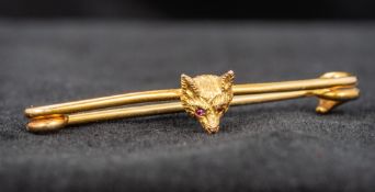 A 9 ct gold ruby set fox mask brooch 4.5 cm long overall.