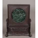 A Chinese jade inset carved hardwood table screen The removable panel centred with a jade roundel