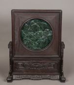 A Chinese jade inset carved hardwood table screen The removable panel centred with a jade roundel