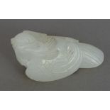 A Chinese carved white jade bird Naturalistically carved. 6 cm wide.